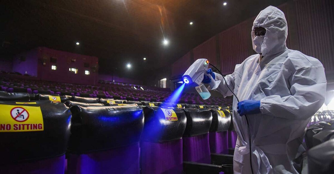 A worker cleans a hall, as theatres prepare to re-open from tomorrow after nearly nine months of closure due to coronavirus lockdown, in Hyderabad, Thursday, Dec. 24, 2020. (PTI Photo) 