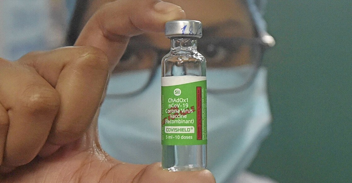 A medic shows a vial containing doses of Covishield vaccine during a countrywide COVID-19 inoculation drive, in Howrah district, Monday, Jan. 18, 2021. (PTI Photo/Swapan Mahapatra)