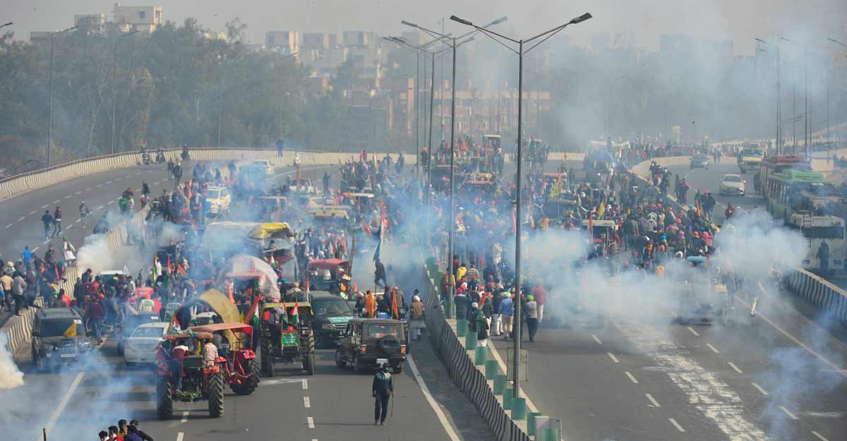 Police fire teargas shells to disperse protesting farmers who were attempting to break barricades at Ghazipur border during their 'tractor march' on Republic Day, in New Delhi, Tuesday. Photo: PTI