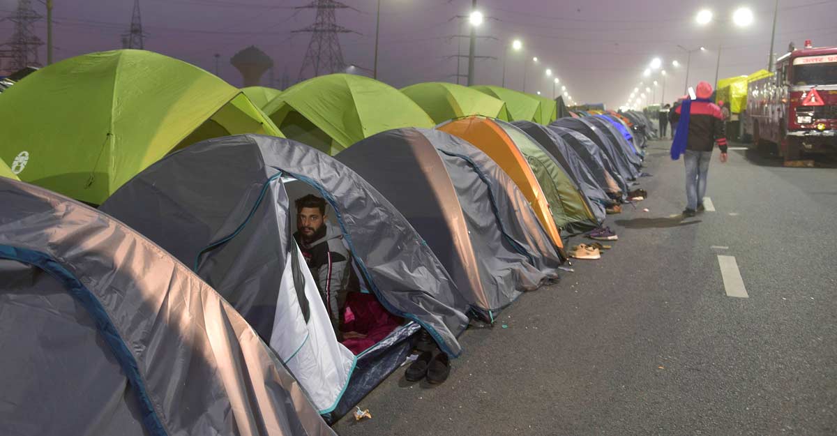 Farmers rest inside their makeshift tents at Delhi-UP Ghazipur border, during their protest against new farm law, in Ghaziabad, Thursday, Jan. 7, 2021. (PTI Photo/Vijay Verma)