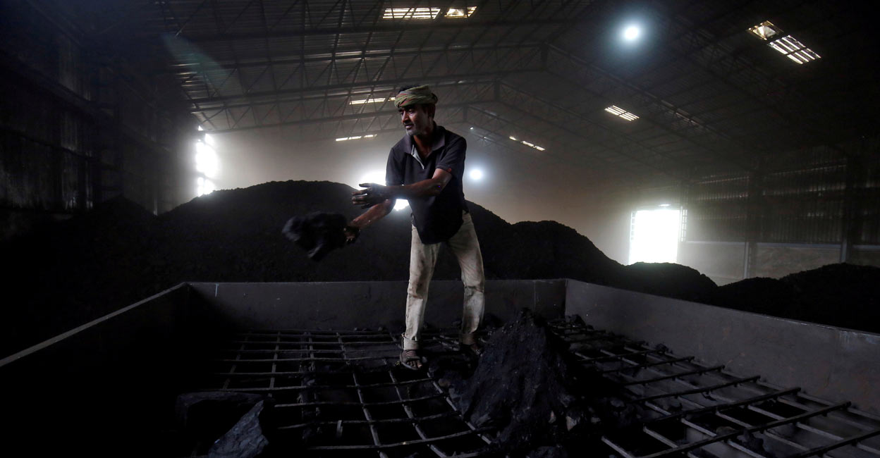 A labourer works inside a coal yard on the outskirts of Ahmedabad, India, April 6, 2017. File Photo: REUTERS/Amit Dave