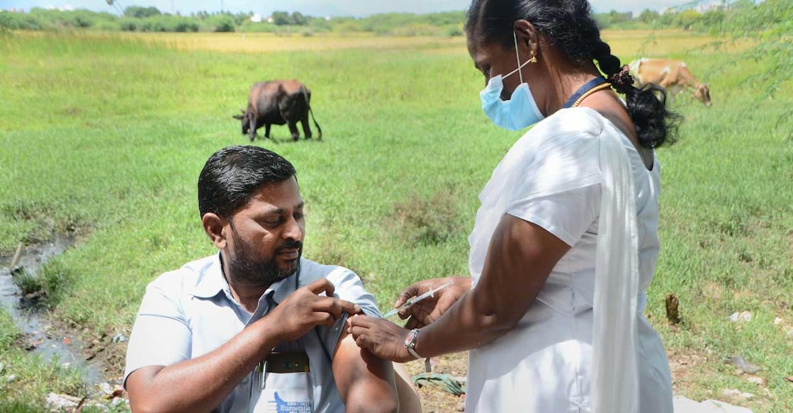 COVID-19 in India A health worker administers a dose of COVID-19 vaccine to a beneficiary, at a field in Tirunelveli, Sunday, Oct. 10, 2021. Photo: PTI