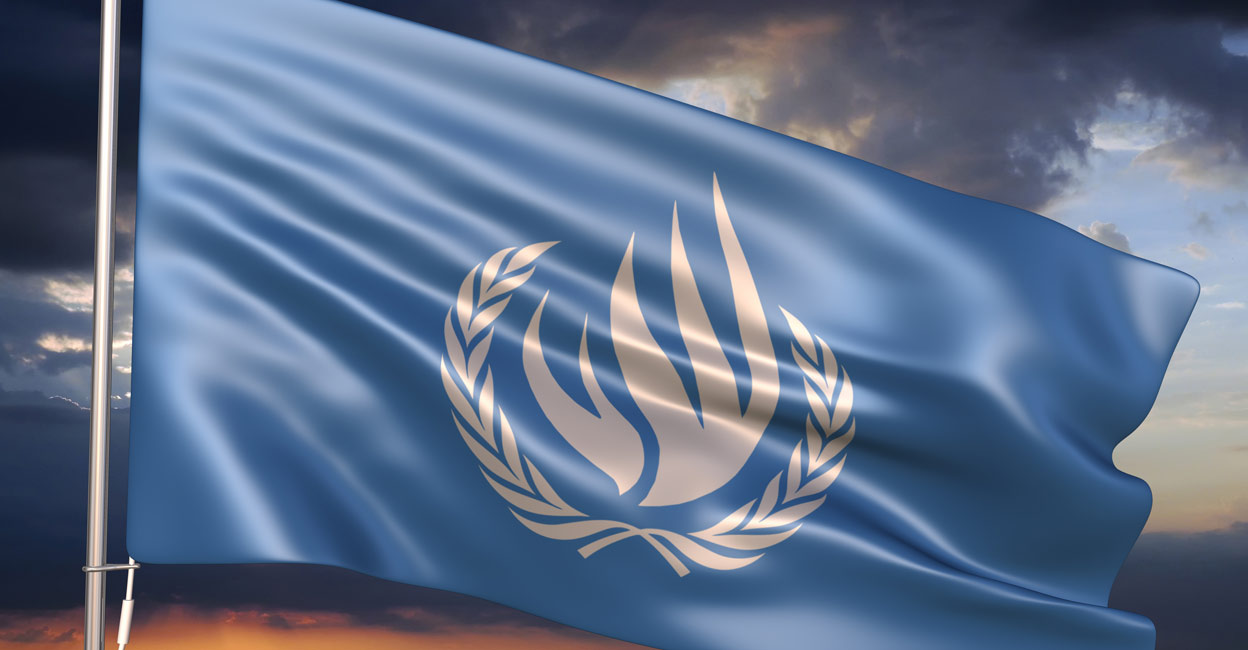 United Nations Human Rights Council (UNHRC) flag waving against sunset sky