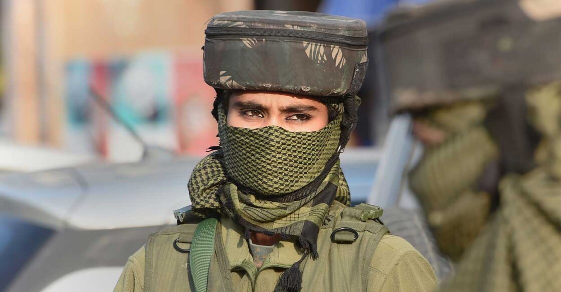 Woman security personnel stands guard during a surprise checking in Srinagar, Monday, Oct. 18, 2021. PTI