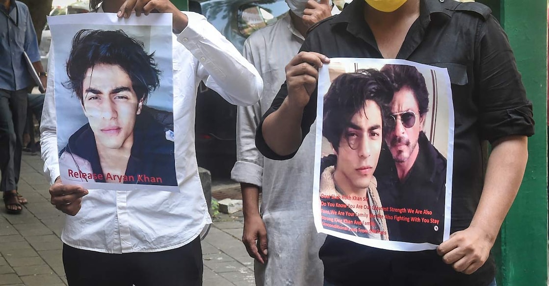 Fan's of Bollywood actor Shah Rukh Khan, hold posters written with 'Release Aryan Khan' stand outside Bombay High court. Photo: PTI