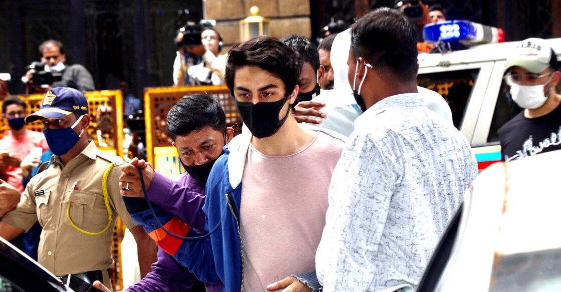 Aryan Khan, arrested in drugs case, being escorted at the NCB office. Photo: PTI