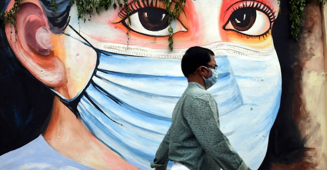 A man walk past a mural on novel coronavirus in Thiruvananthapuram, October 3 , 2021. Photo: PTI
