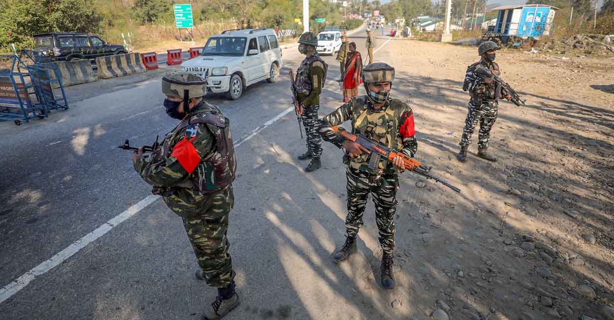 PTI11_22_2021_000024B CRPF personnel stand guard on strategic Jammu-Srinagar national highway on Nov 22, 2021. Security has been put on alert across Jammu following a grenade attack outside an army camp in Pathankot in Punjab. Photo: PTI