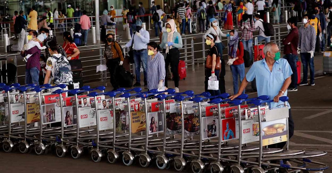 An airport staff member pushes trollies at the entrance of Chhatrapati Shivaji International Airport, after the government allowed domestic flight services to resume, during an extended nationwide lockdown to slow the spread of COVID-19, in Mumbai, May 25, 2020. Photo: REUTERS/Francis Mascarenhas