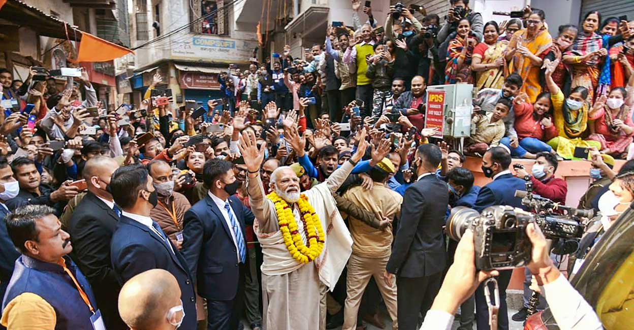  Prime Minister Narendra Modi greets people in his parliamentary constituency, in Varanasi, Monday, Dec. 13, 2021. PM Modi is set to inaugurate the redeveloped Kashi Vishwanath corridor. (PTI Photo)