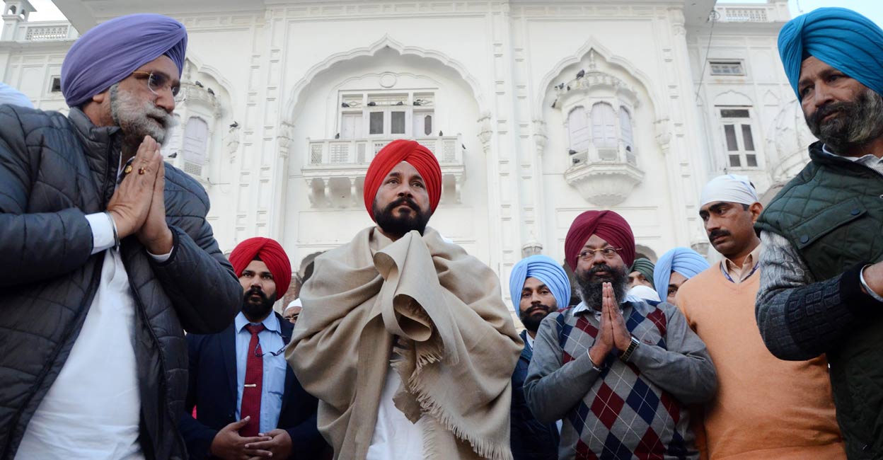 PTI12_19_2021_000211B Punjab Chief Minister Charanjit Singh Channi (centre) and Deputy Chief Minister Sukhjinder Singh Randhawa (L) offer prayers at the Golden Temple, in Amritsar, Sunday, Dec. 19, 2021. Photo: PTI
