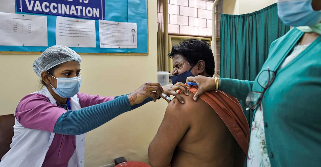A medic administers the first dose of Covaxin vaccine to a frontline worker, during an COVID-19 inoculation drive, at Sanjeevan Hospital in New Delhi, Saturday. Photo: PTI