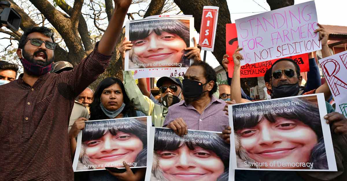 People hold placards during a protest against the arrest of climate activist Disha Ravi People hold placards during a protest against the arrest of climate activist Disha Ravi