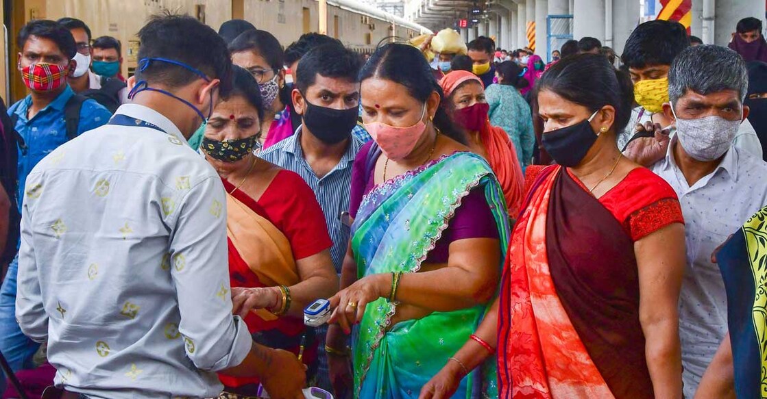 A health worker conducts the screening of passengers after they arrived via a train, at Dadar Station in Mumbai, Sunday, March 14, 2021. (PTI Photo)