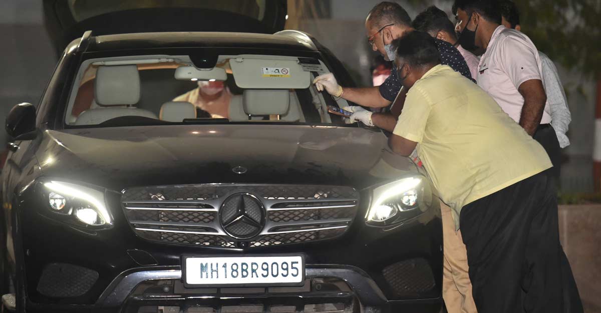 NIA officers inspect the seized Benz car NIA officers inspect the seized Benz car