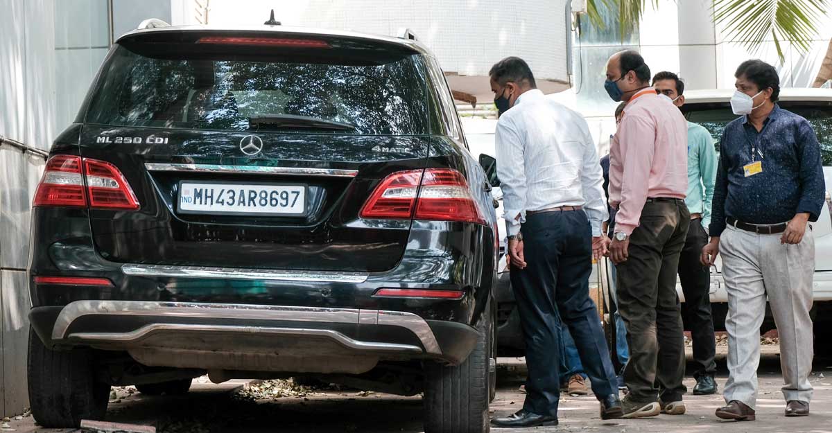 Mumbai NIA forensic experts investigate seized high-end cars, in connection with a probe into the recovery of explosives from a car parked near industrialist Mukesh Ambanis house, in Mumbai, Friday, March 19, 2021. (PTI Photo)