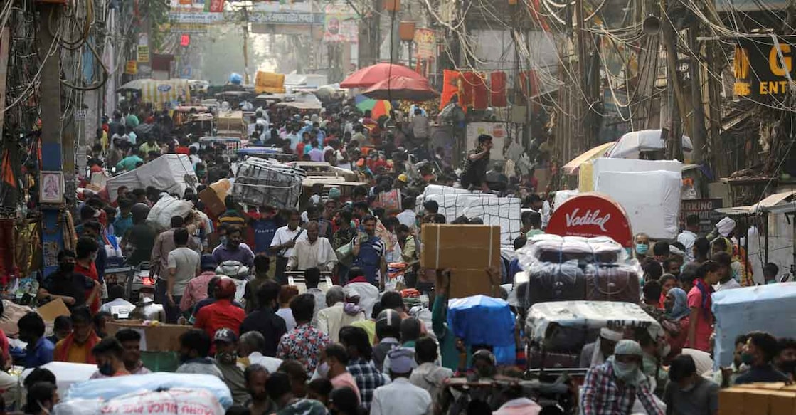 People walk at a crowded market amidst the spread of the coronavirus disease (COVID-19), in the old quarters of Delhi, India, April 6, 2021. REUTERS/Anushree Fadnavis