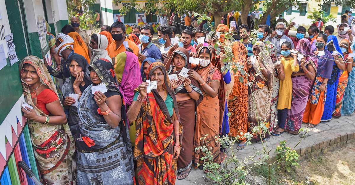 Villagers stand in queue to cast theirvote at the polling station, during the first phase of Uttar Pradesh Gram Panchayat election, in a village Phulpur, Prayagraj, Thursday. PTI