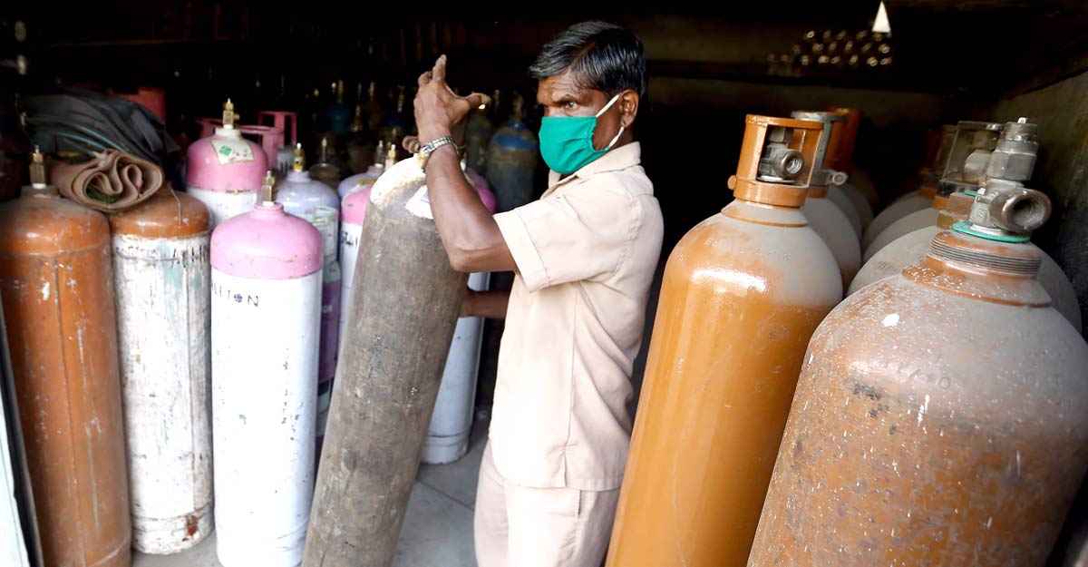  worker sorts medical oxygen cylinders for COVID-19 patients, in Mumbai, Saturday, April 24, 2021.  Photo: