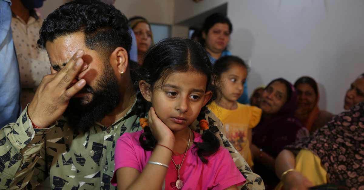 A relative holding the daughter of Indian paramilitary soldier Rakeshwar Singh Manhas wails at their residence in Jammu A relative holding the daughter of Indian paramilitary soldier Rakeshwar Singh Manhas wails at their residence in Jammu, India, Monday, April 5, 2021. Photo: PTI