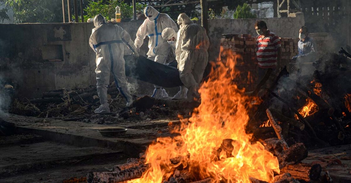 Family members perform last rites of a Covid-19 patient at a cremation ground, amid a surge in Coronavirus cases across the country, in Jalandhar. PTI