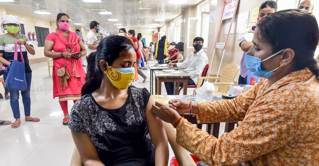 A beneficiary receives a dose of the COVID-19 vaccine at Moti Lal Nehru Medical College in Prayagraj. PTI