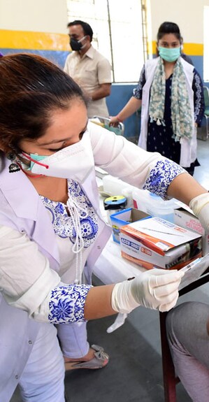 COVID-19 A medic administers a dose of COVID-19 vaccine to a young person, at a vaccination centre in New Delhi. PTI