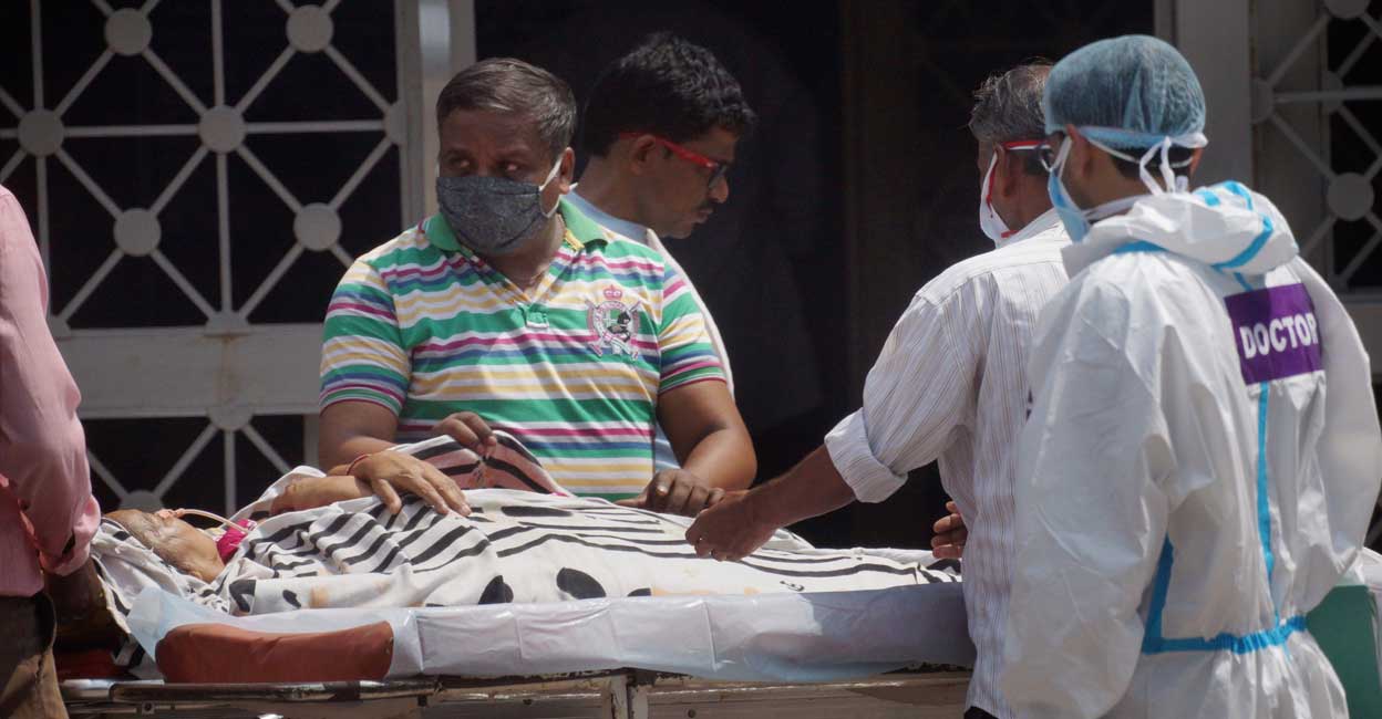 A Covid-19 patient waits to be admitted at LNJP hospital for treatment, in New Delhi, Monday, June 14, 2021. Photo: PTI