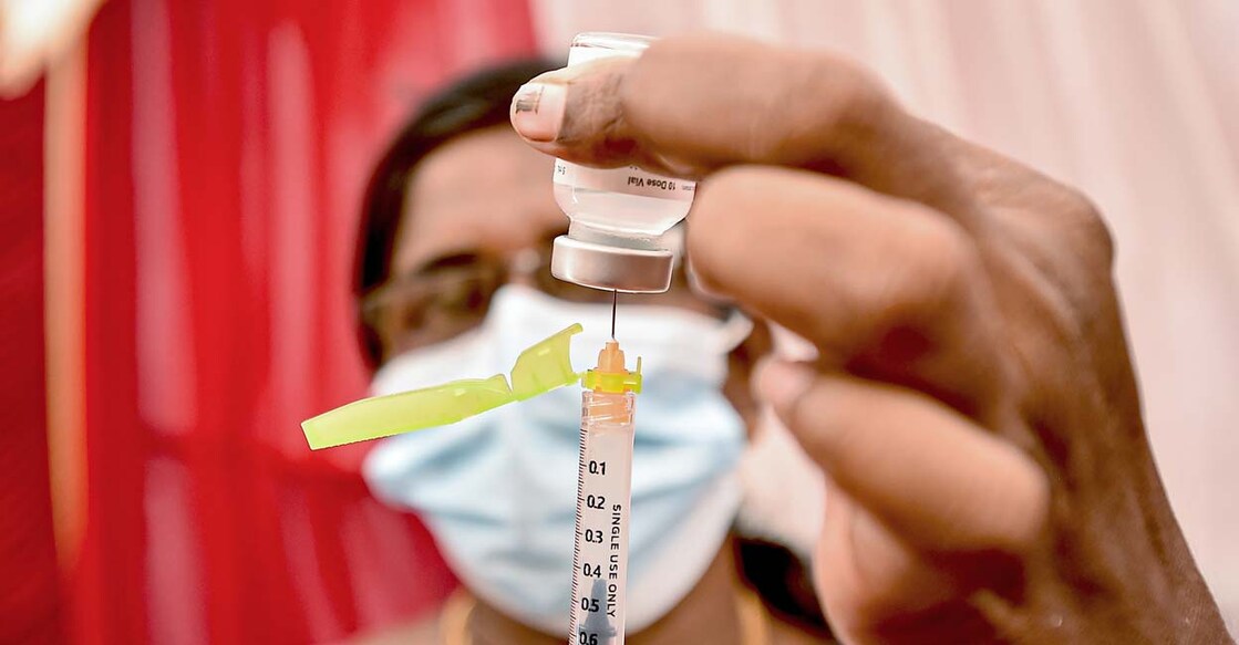 A health worker fills a syringe with a dose of the COVID-19 vaccine at a vaccination centre in Chennai. PTI