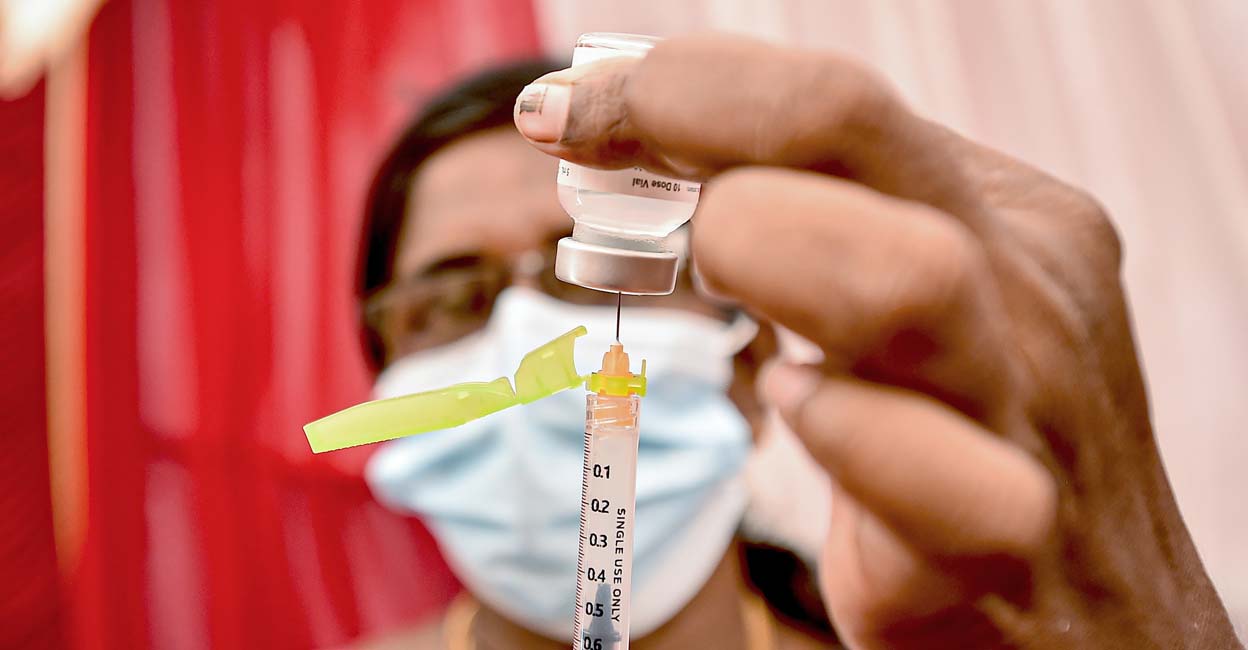 A health worker fills a syringe with a dose of the COVID-19 vaccine at a vaccination centre in Chennai. PTI