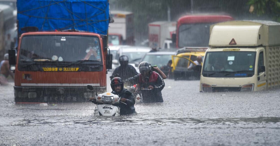Vehicles make their way through the waterlogged road during heavy rain at Kings Circle in Mumbai on Wednesday, June 9, 2021. PTI