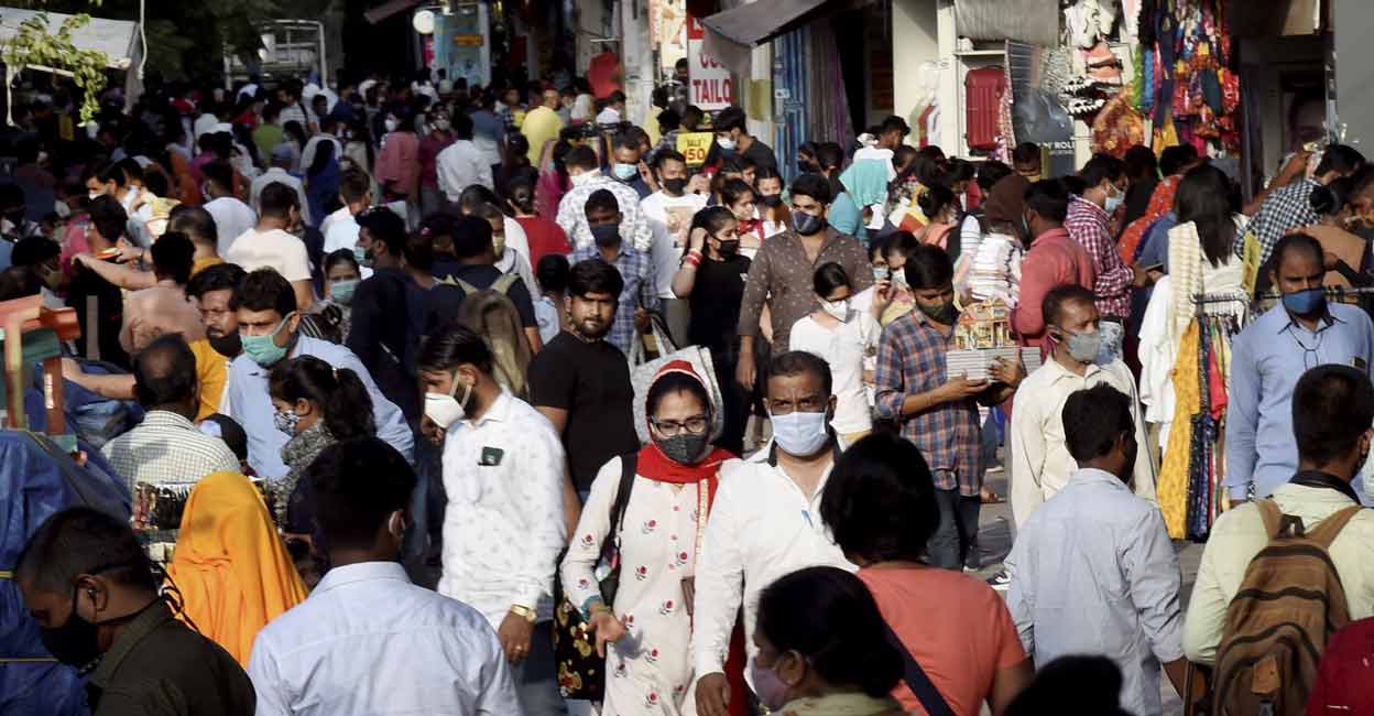 People, flouting COVID-19 appropriate behavior, visit a crowded Sarojini Market area during the ongoing coronavirus pandemic in New Delhi. PTI