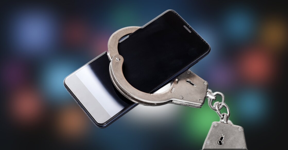 social-meida-arrest-phone-handcuff Representational image: Sabphoto/Shutterstock