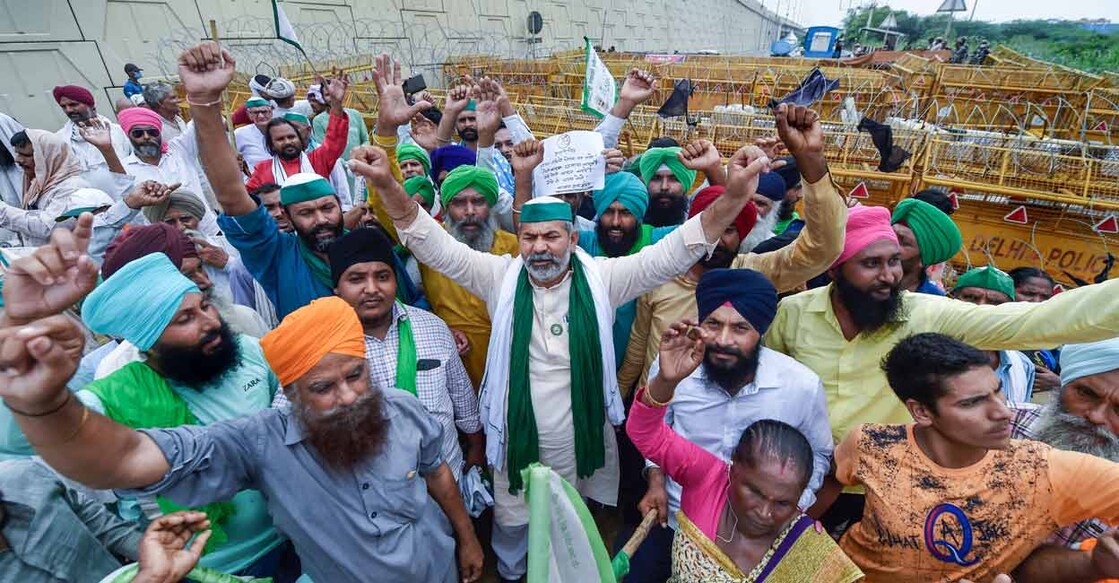 BKU spokesperson Rakesh Tikait and farmers raise slogans during their protest against three farm reform laws, at Ghazipur border in New Delhi, Wednesday, July 21, 2021. Farmers are scheduled to protest march towards Parliament against three farm laws on Thursday. Photo: PTI