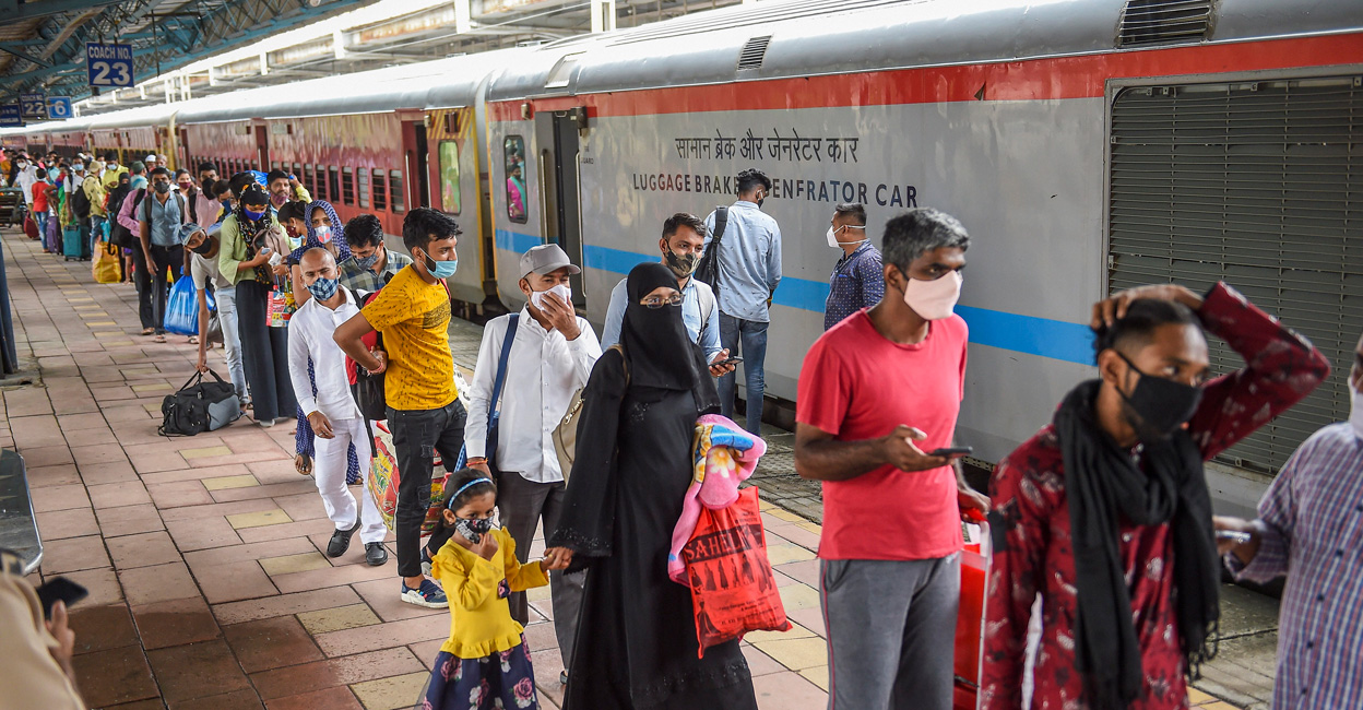 Passengers wait in a queue for their Covid-19 test, at a platform of Dadar railway station in Mumbai. Photo: PTI