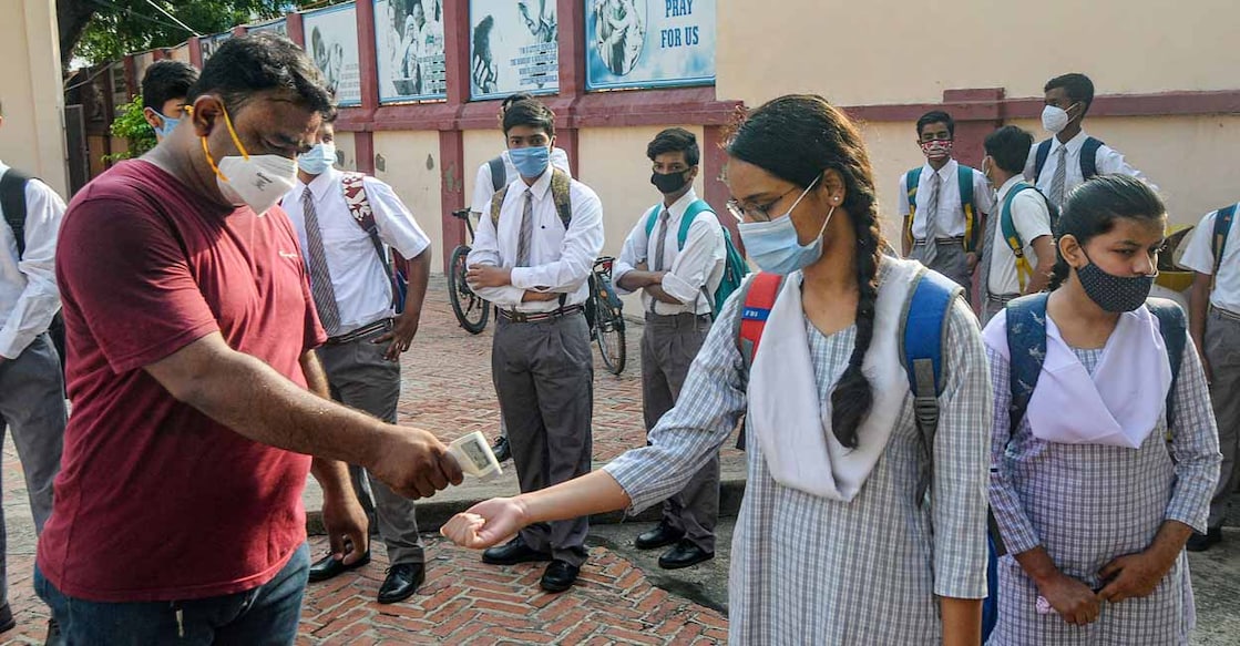 Uttar Pradesh Students undergo thermal screening before entering a school as the Uttar Pradesh government allowed reopening of schools for classes 9th to 12th with Covid-19 guidelines, in Lucknow, Monday, Aug 16, 2021. PTI