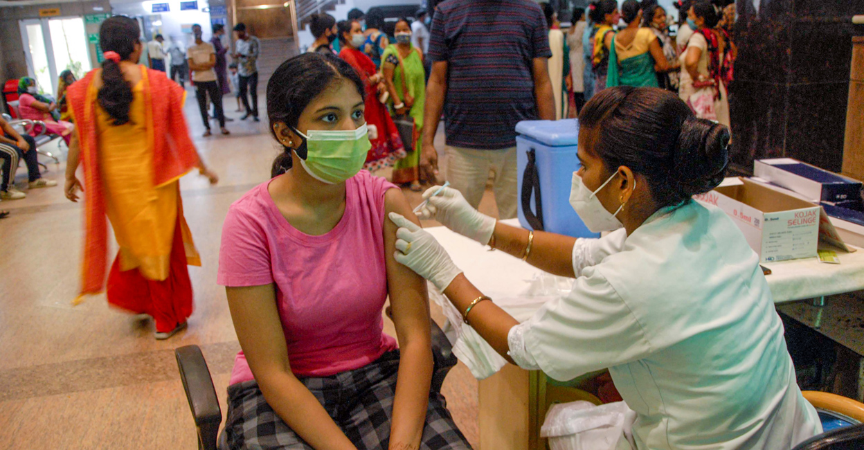 A beneficiary receives COVID-19 vaccine dose, at a district hospital in Noida. Photo: PTI