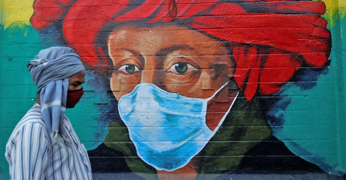 A man walks past a mural on a street, amidst the spread of the coronavirus disease (COVID-19), in Mumbai, January 10, 2022. Photo: Reuters/Francis Mascarenhas