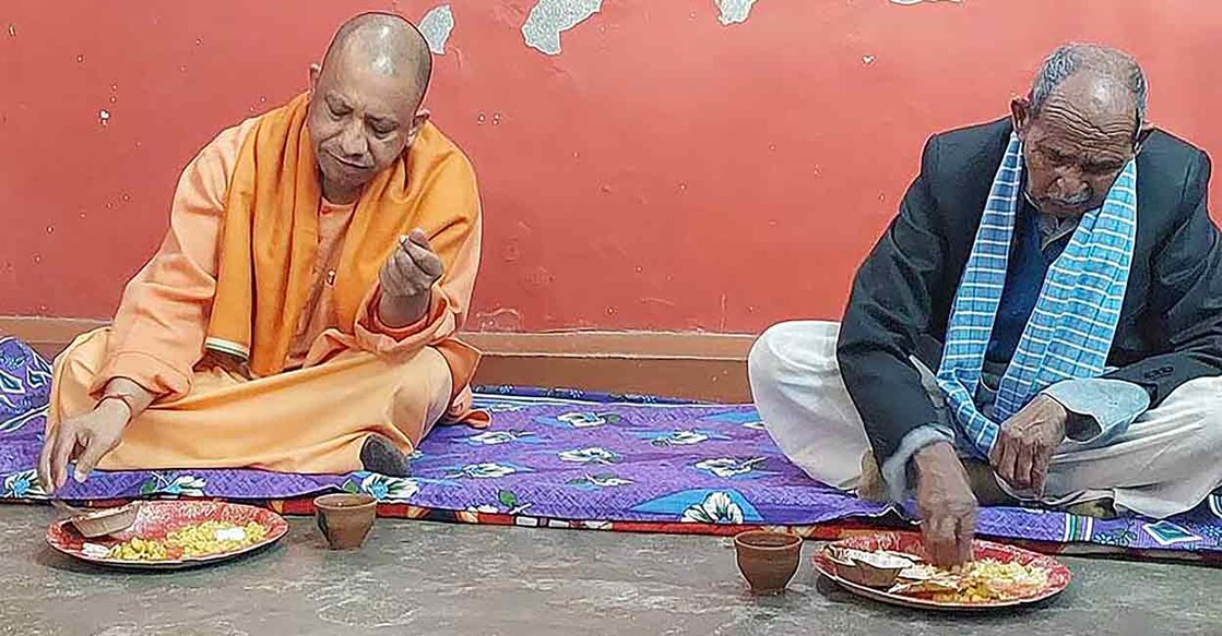 PTI01_14_2022_000165B Uttar Pradesh Chief Minister Yogi Adityanath has lunch with BJP worker at his residence, in Gorakhpur. File photo: PTI