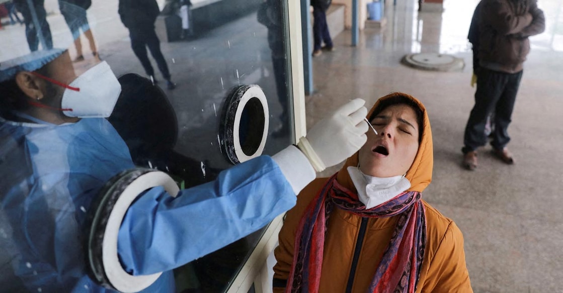India records 3.47 lakh new COVID-19 cases in 24hrs, active cases cross 20-lakh mark A healthcare worker collects a test swab sample from a woman amidst the spread of the coronavirus disease (COVID-19), at a testing centre inside a hospital in New Delhi, India, January 14, 2022. Reuters/Anushree Fadnavis/File Photo