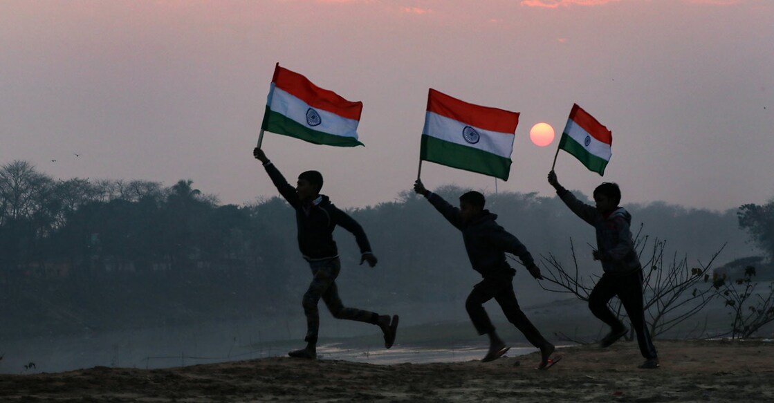 PTI01_25_2022_000198A Children hold the Tricolor during sunset, on the eve of Republic Day 2022. Photo: PTI
