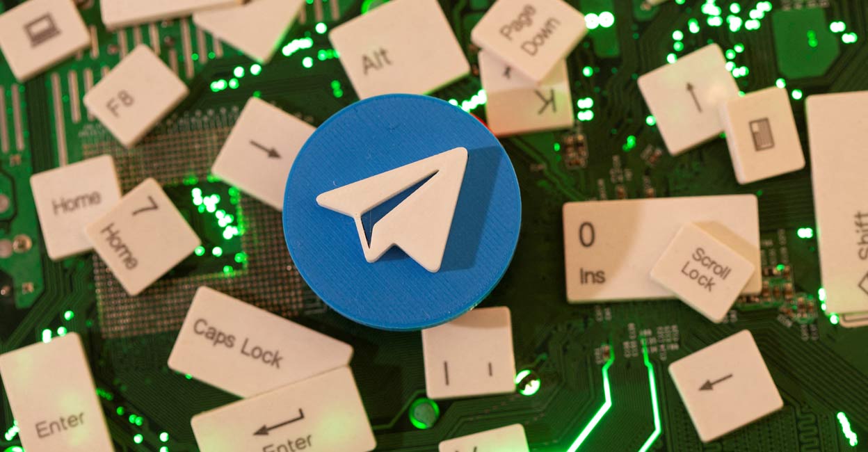 A 3D printed Telegram logo and keyboard buttons are placed on a computer motherboard in this illustration. File Photo: Reuters/Dado Ruvic
