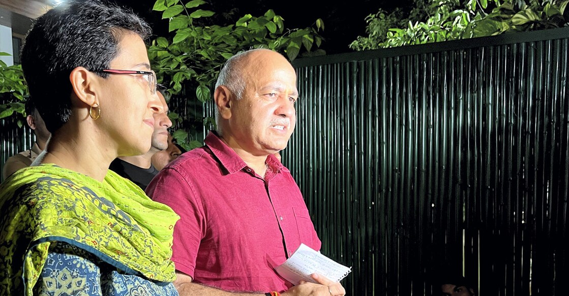 Delhi Deputy Chief Minister Manish Sisodia speaks with media on his return from the CBI headquarters after questioning in connection with the Delhi excise policy probe. AAP leader Atishi Marlena is also seen. Photo: PTI