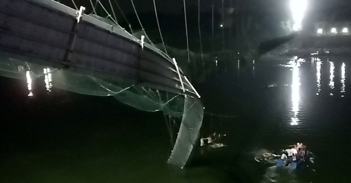 A view shows a damaged part of a suspension bridge after it collapsed in Morbi, Gujarat on Sunday evening. Photo: Reuters