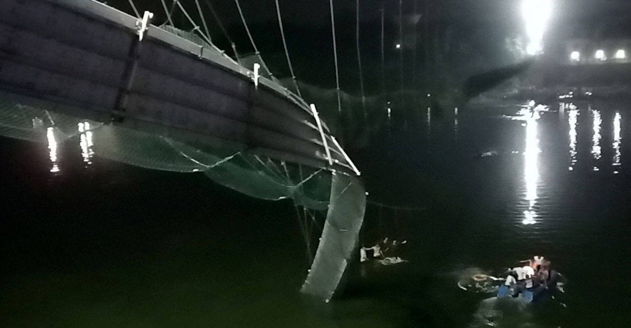 A view shows a damaged part of a suspension bridge after it collapsed in Morbi, Gujarat on Sunday evening. Photo: Reuters