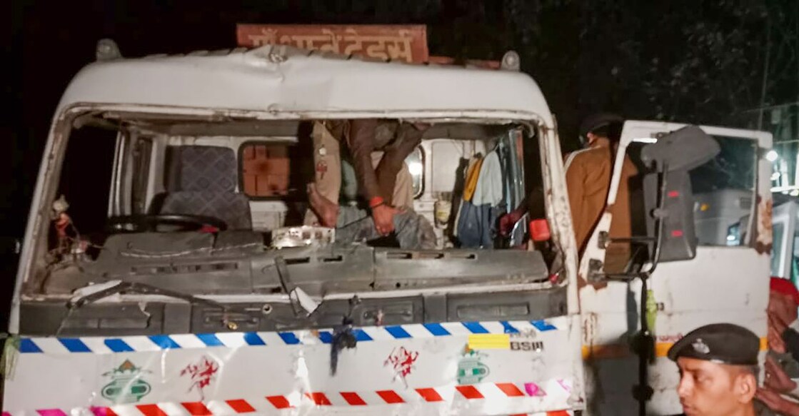 Police personnel rescue the driver of a truck that ploughed into a religious procession, killing at least eight people, in Vaishali district, Bihar, Sunday night, November 20, 2022. Photo: PTI
