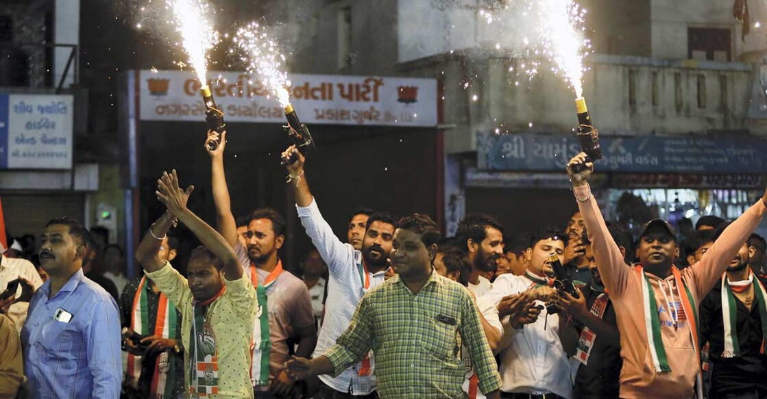 Congress supporters burn firecrackers as they attend a public meeting ahead of the upcoming Gujarat Assembly elections, in Ahmedabad: PTI