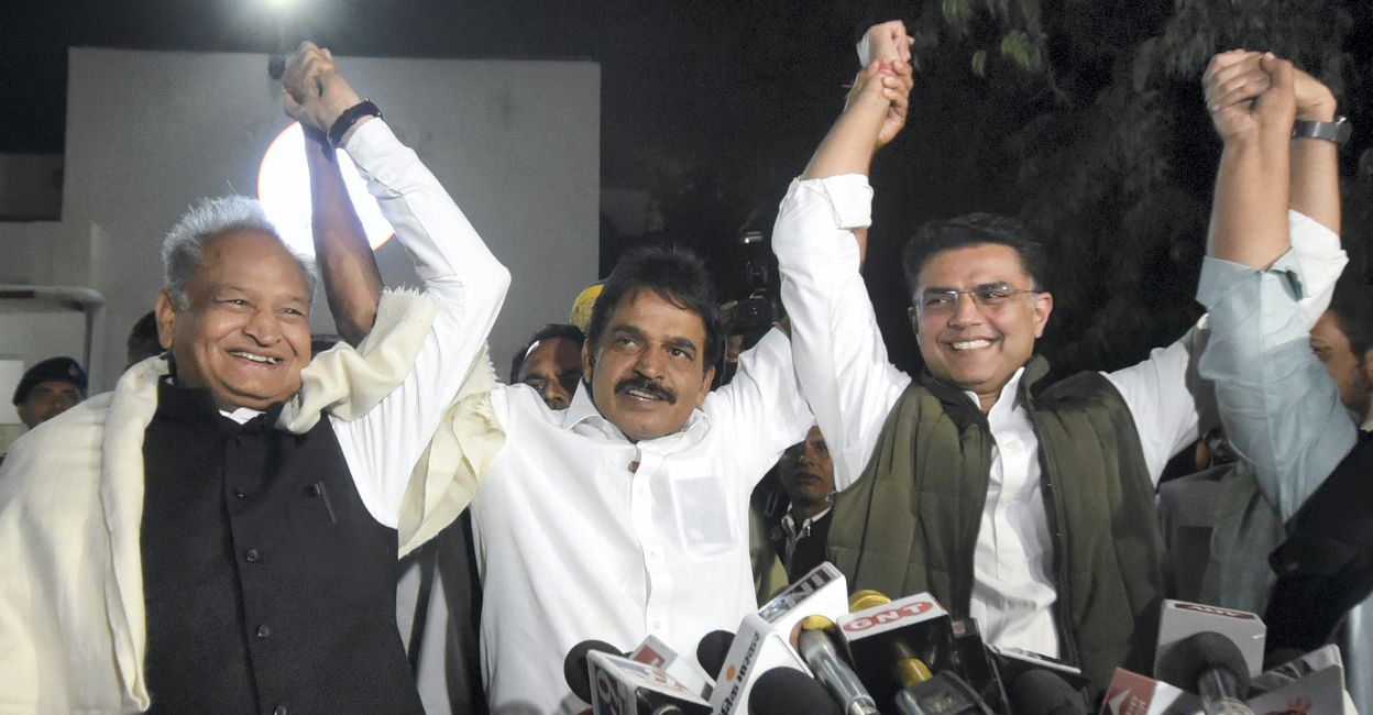 Congress General Secretary KC Venugopal raises his hands with Rajasthan Chief Minister Ashok Gehlot and party leader Sachin Pilot during the state-level coordination committee meeting on 'Bharat Jodo Yatra' at party headquarters, in Jaipur, Tuesday, November 29, 2022. Photo: PTI