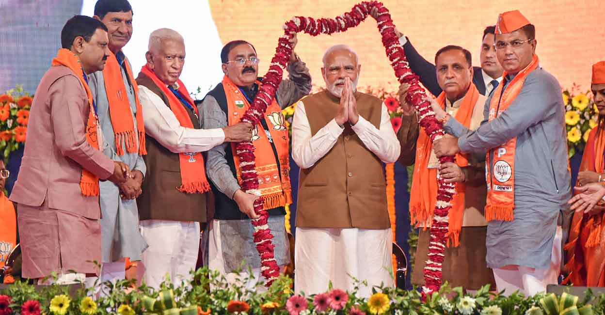 Gujarat Prime Minister Narendra Modi being garlanded during a public meeting ahead of Gujarat Assembly elections, in Rajkot, Monday, Nov. 28, 2022. Photo: PTI Photo