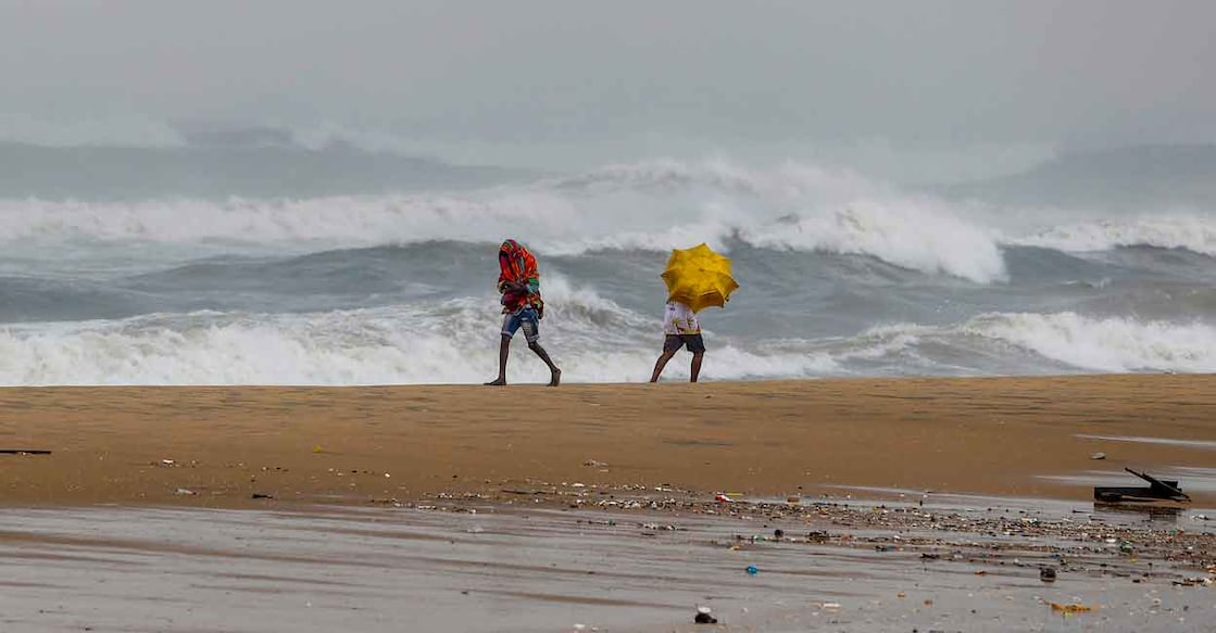 Youngsters react as waves crash at the sea-shore ahead of the landfall of cyclonic storm Mandous, in Chennai, Friday, Dec. 9. Photo: PTI